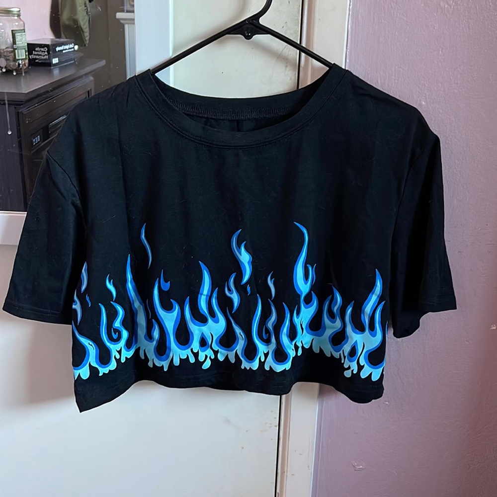 Black crop top with blue flames at the end.